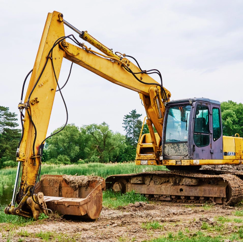 excavator clearing a yard